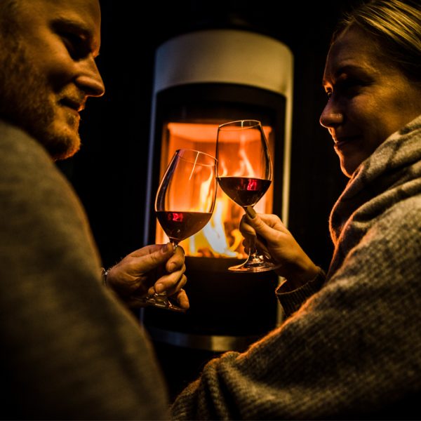 Couple enjoying red wine in Arctic Scene Executive Suites at the Arctic TreeHouse Hotel.