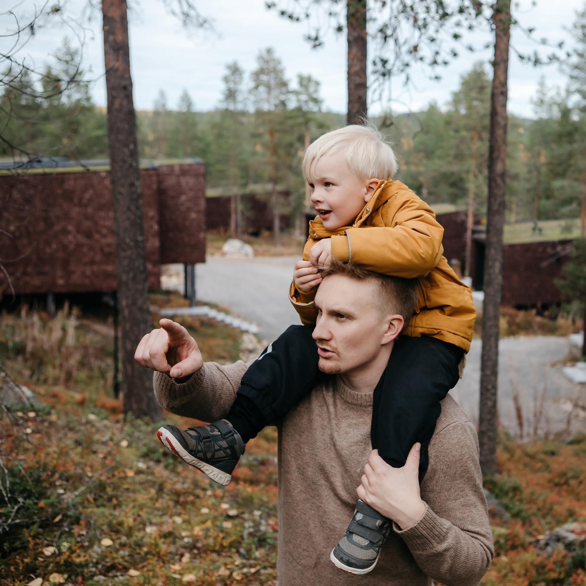 A father and son exploring the autumn colors at Arctic TreeHouse Hotel Rovaniemi
