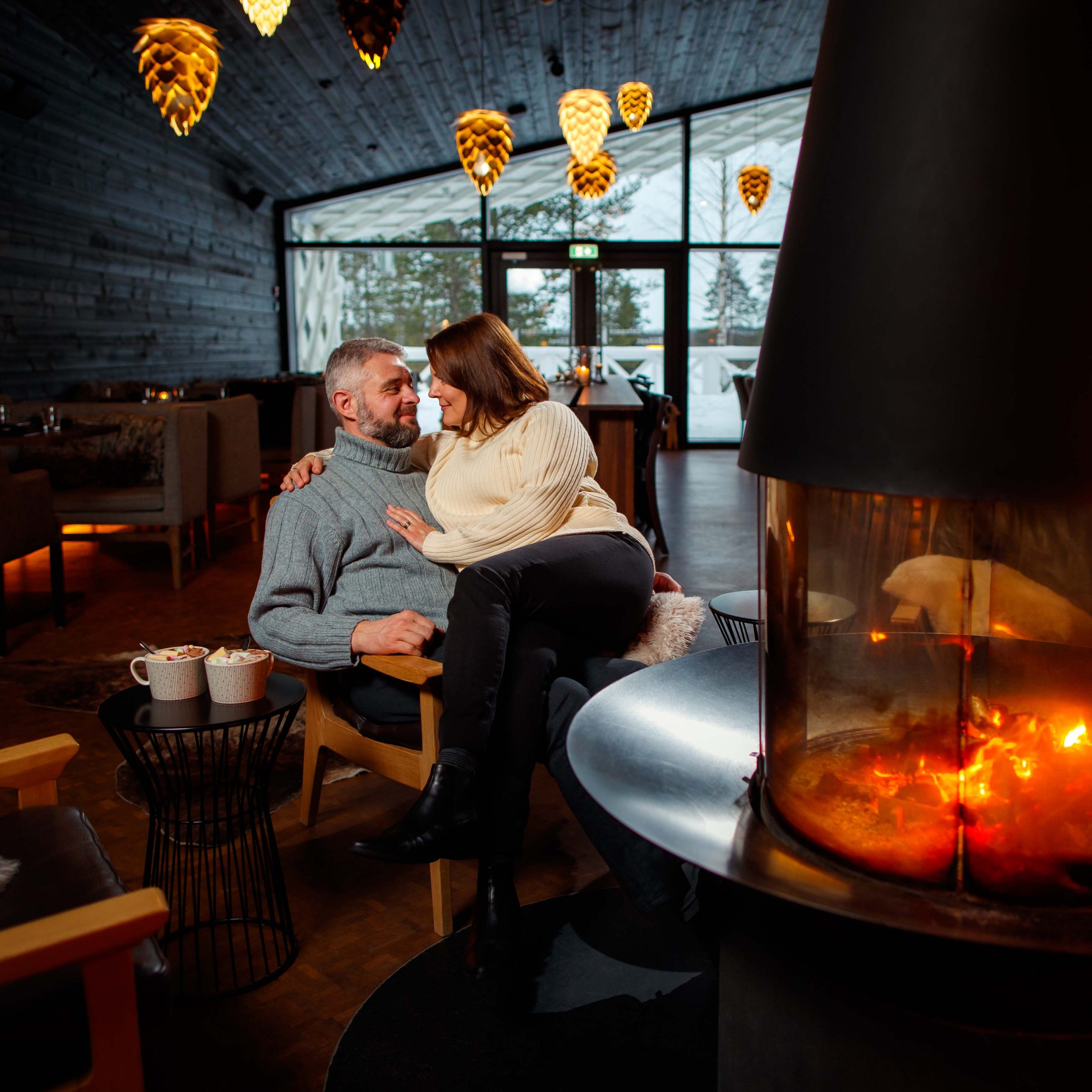A couple enjoying romantic atmosphere at Rakas Restaurant in Arctic TreeHouse Hotel