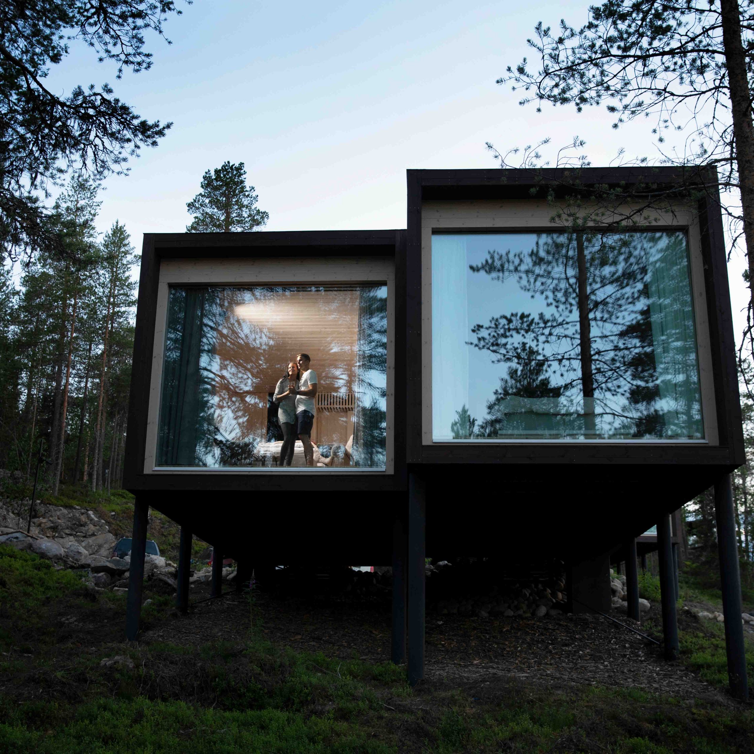 Couple enjoying of the white nights during July in Rovaniemi, Arctic TreeHouse Hotel