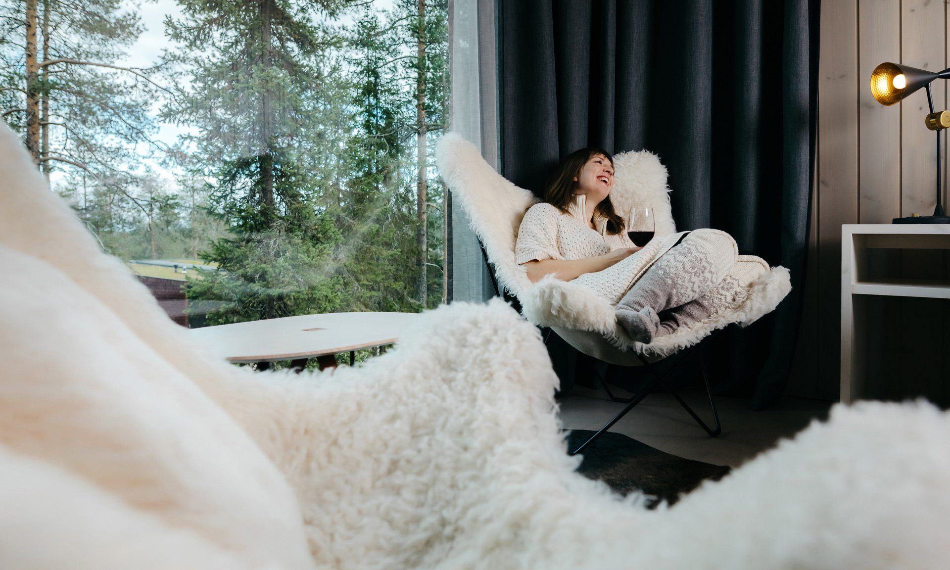 A woman enjoying her holiday in the Arctioc TreeHouse Suite.