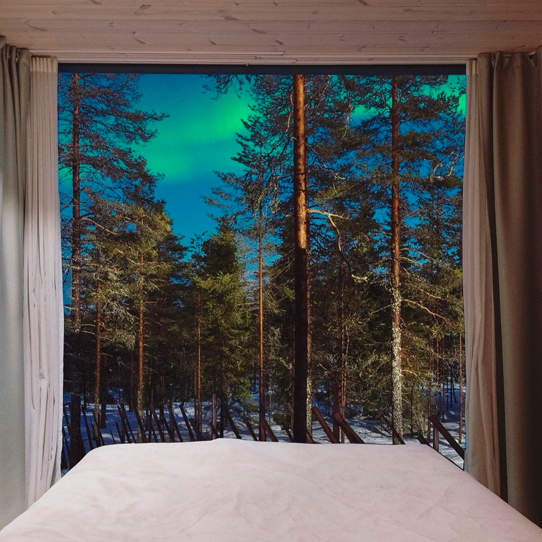 Northern lights through the Arctic TreeHouse Suite window.