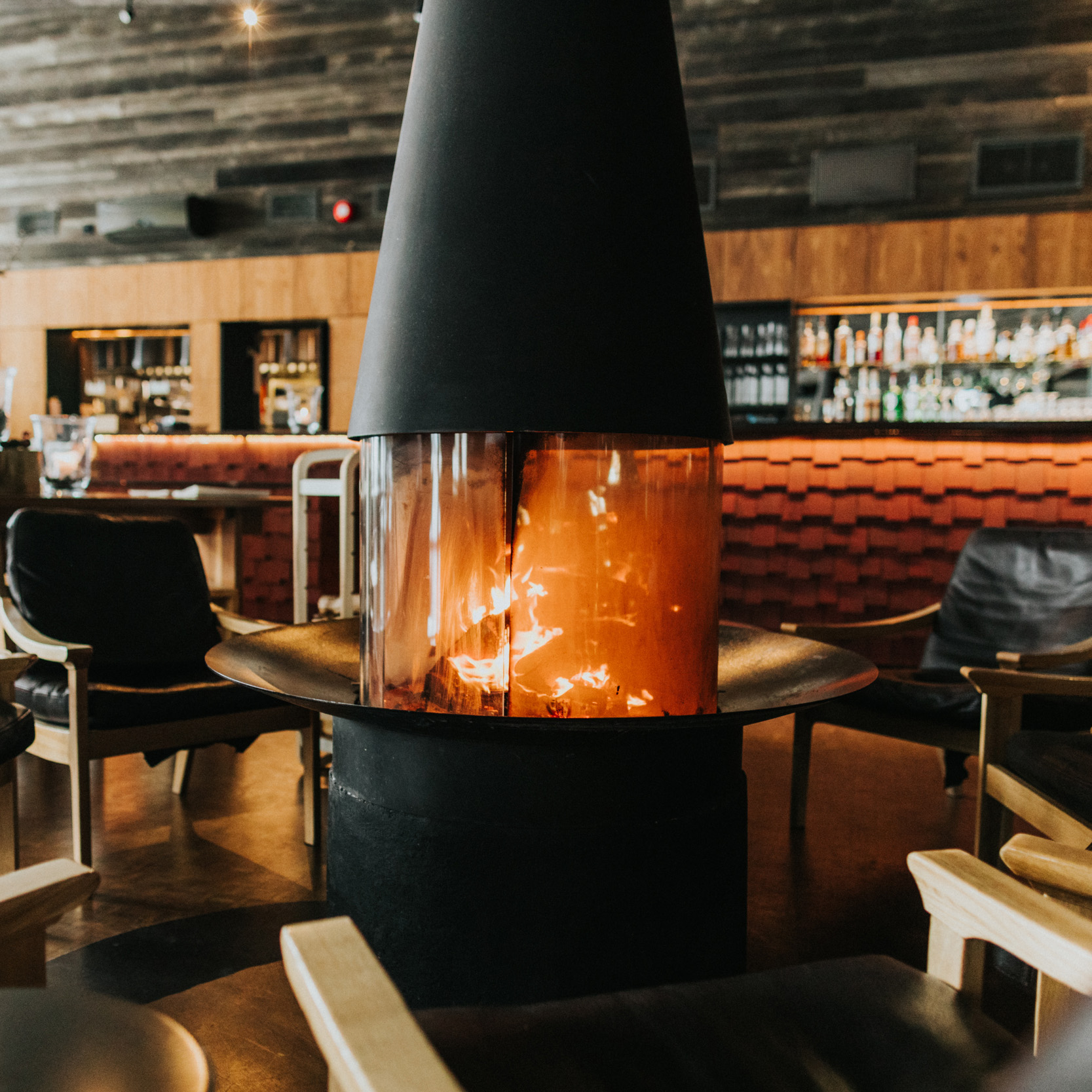 Atmosphere-rich Rakas Restaurant with center-piece fireplace.