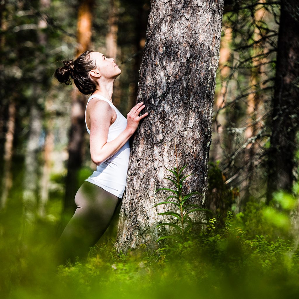A woman enjoying the wellbeing from the forest of Lapland.