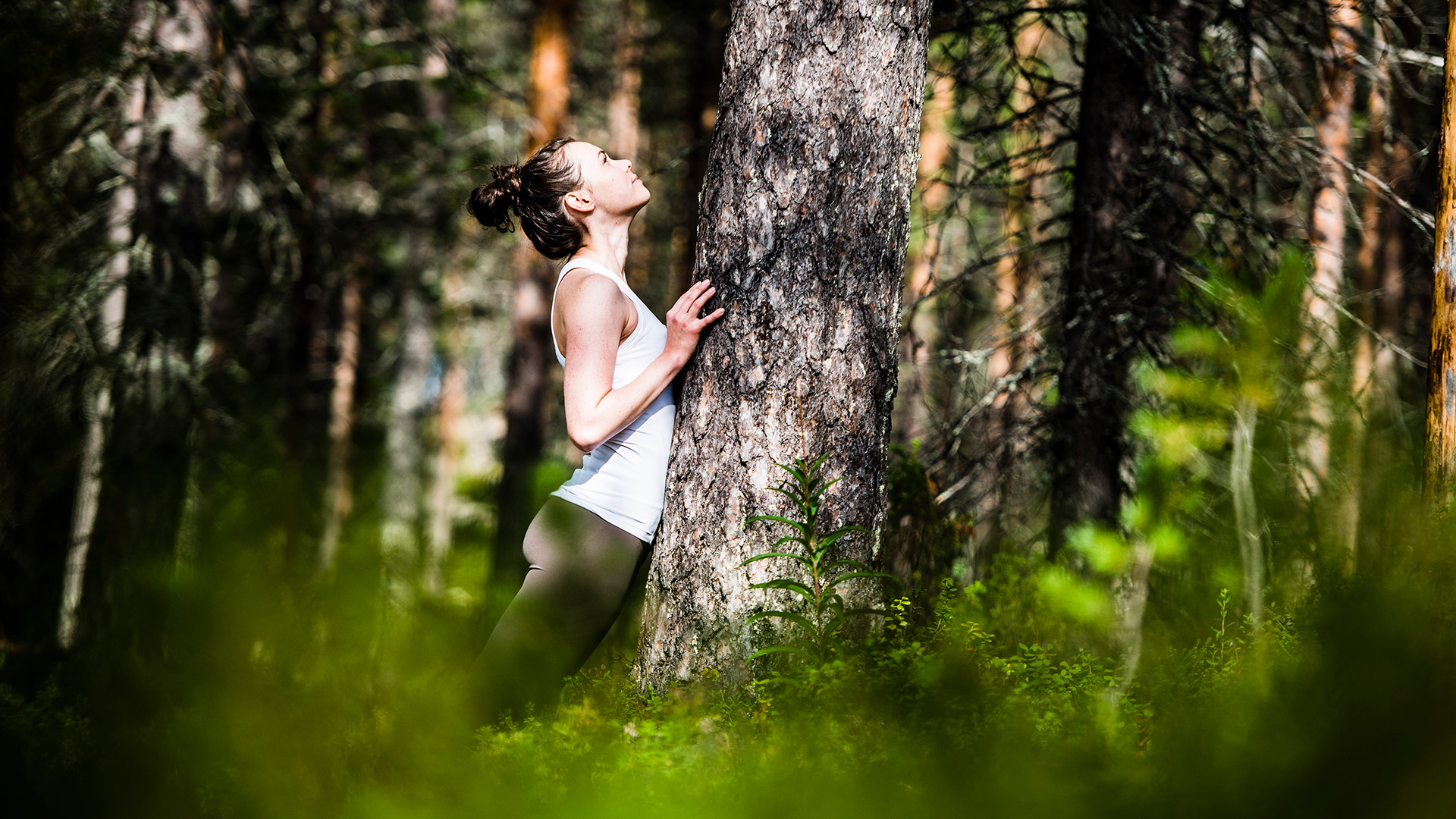 A woman enjoying the wellbeing from the forest of Lapland.
