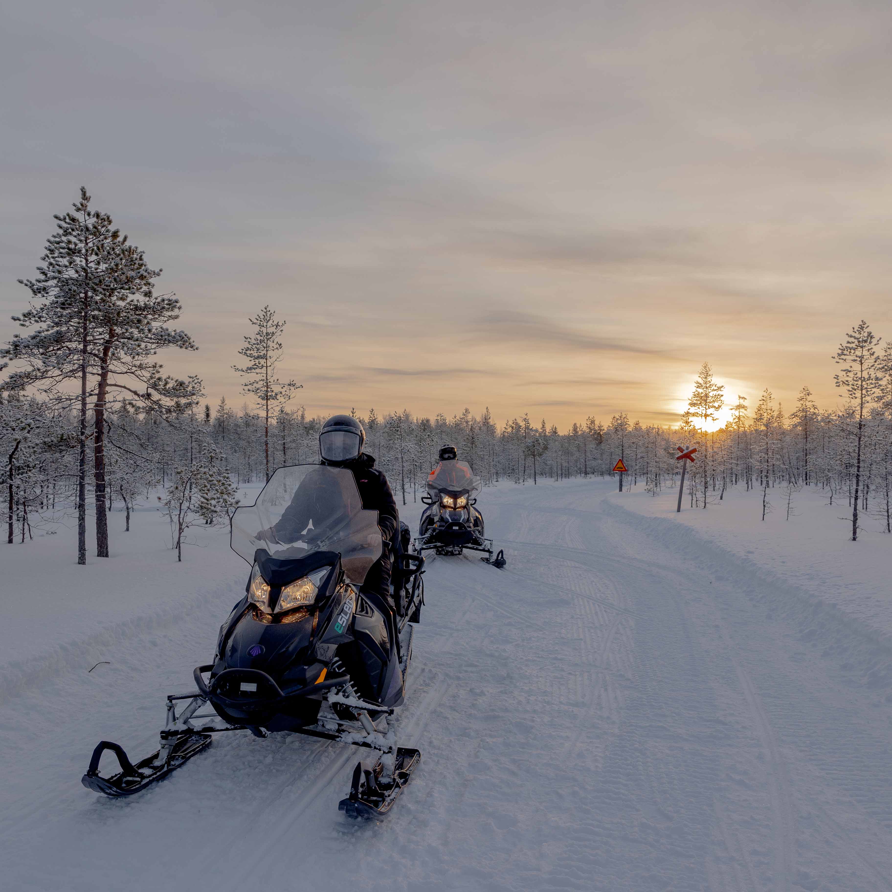 E-snowmobile adventture in snowy forest in Rovaniemi, Lapland.
