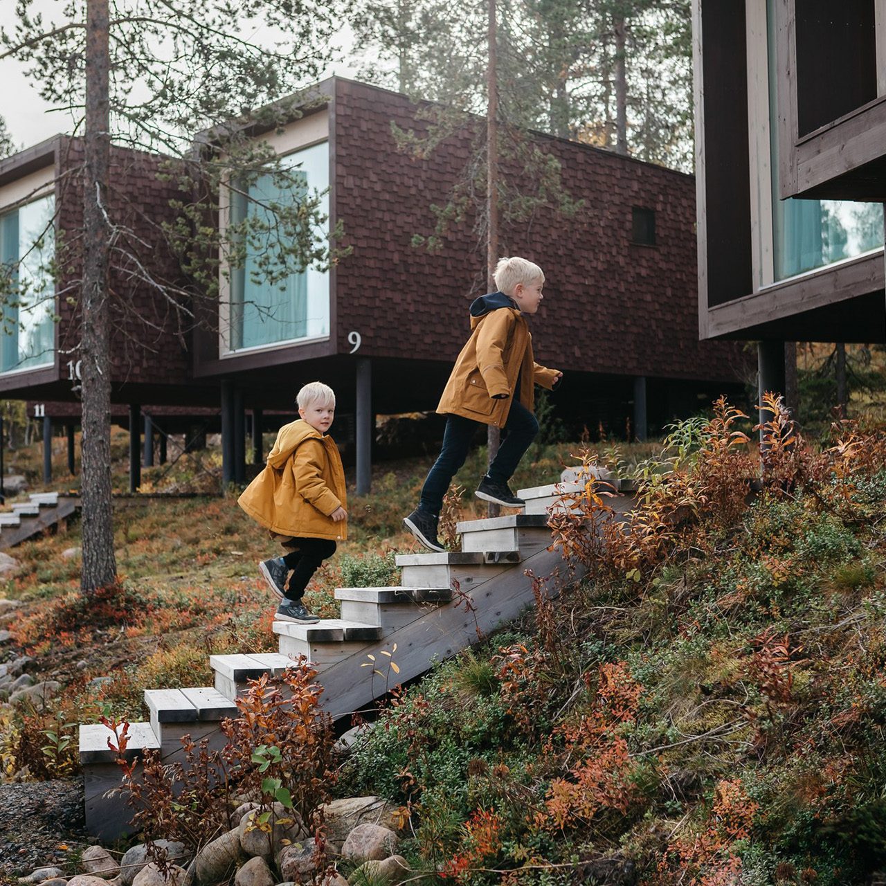 Two children heading to Arctic TreeHouse Suites in autumn.