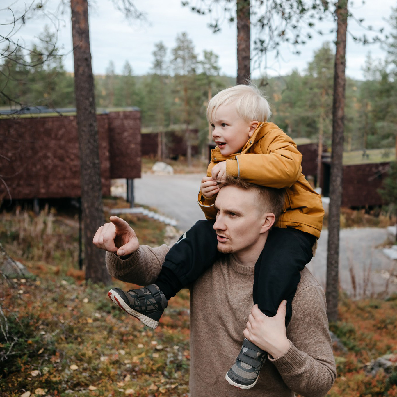 Father and child enjoying the arctic nature at Arctic TreeHouse Hotel.