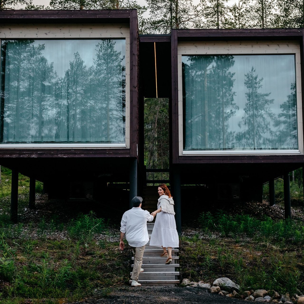 Couple enjoying arctic summer at the Arctic TreeHouse Hotel. | Rovaniemi