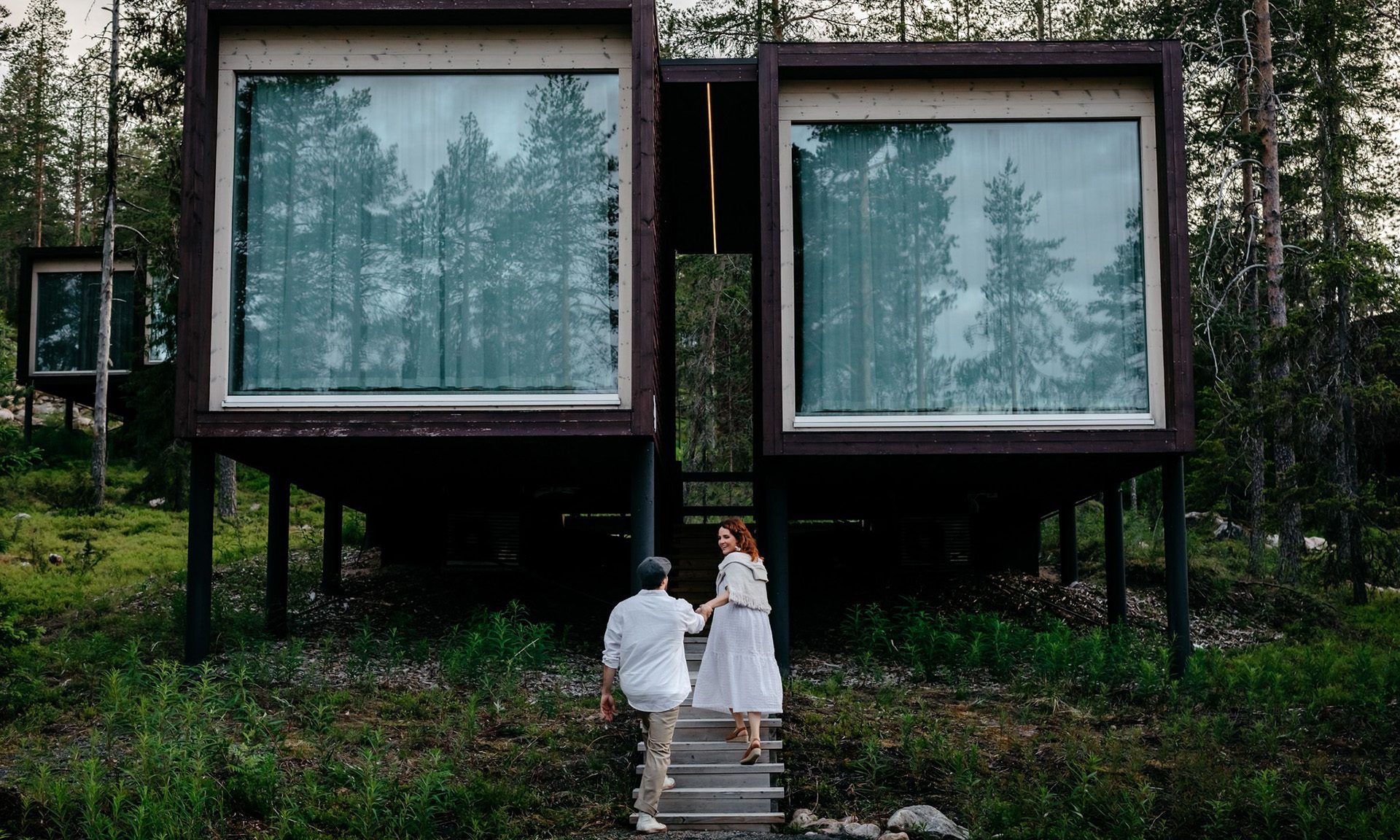 Couple enjoying arctic summer at the Arctic TreeHouse Hotel. | Rovaniemi