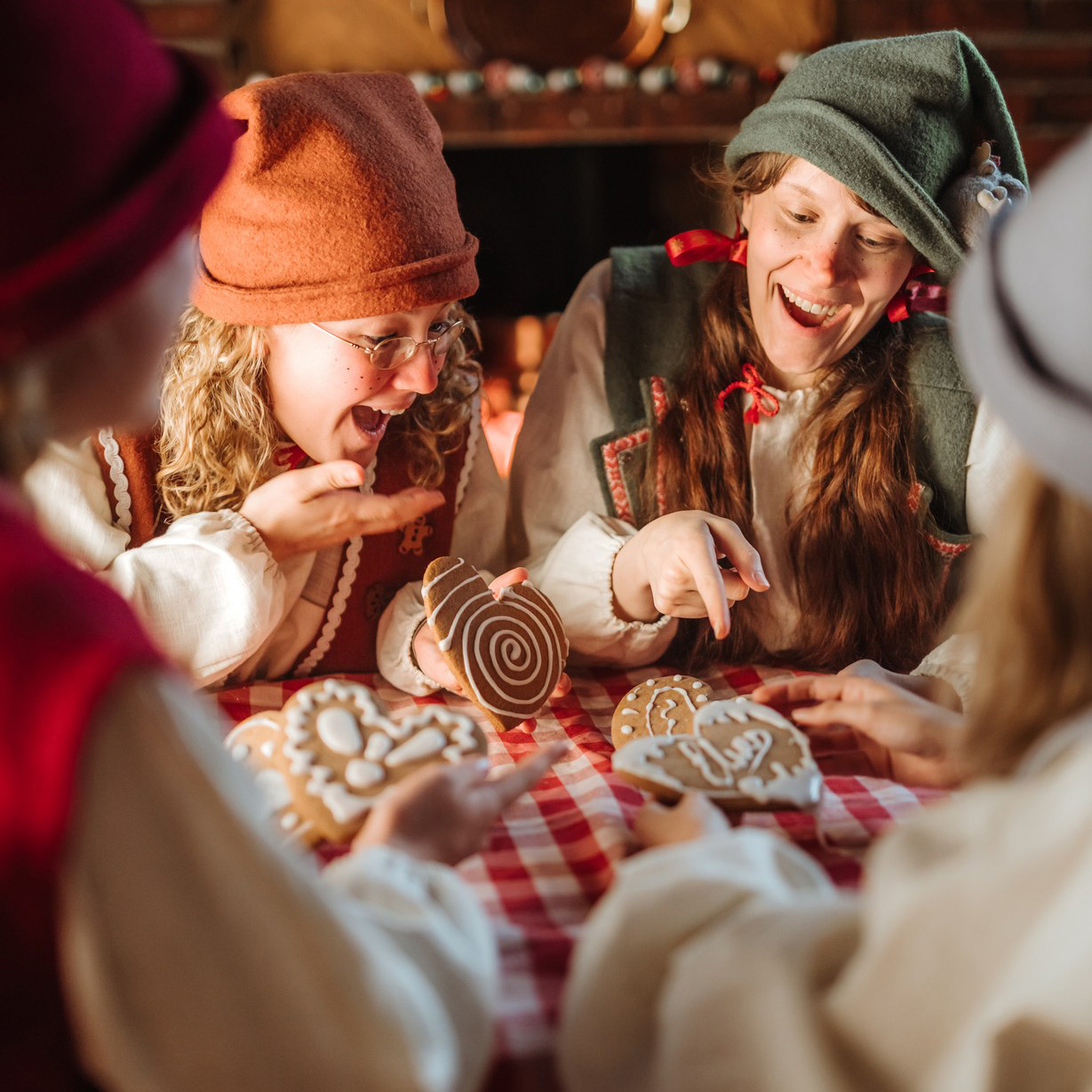 Elves decorating gingerbreads in the Mrs. Gingerbreads bakery.