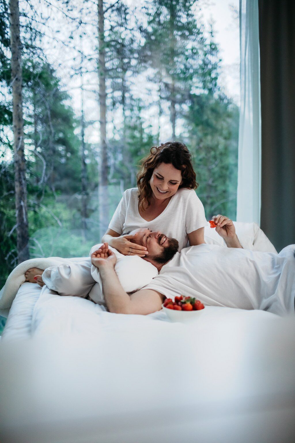 Couple enjoying in Arctic TreeHouse Suite in summer. | Rovaniemi, Finland.