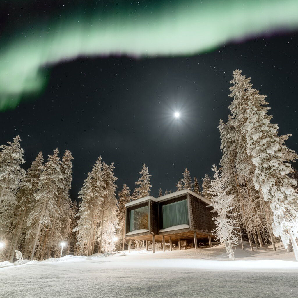 Northern Lights dancing above Arctic Scene Executive Suites. In Rovaniemi, Lapland, Finland.