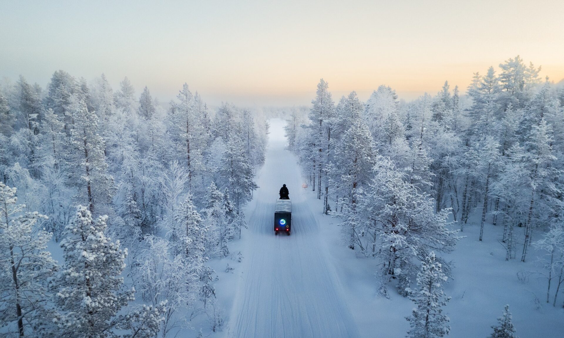 Heated Sledge gliding through snowy forest to Arctic TreeHouse Hotel. Rovaniemi, Lapland, Finland.